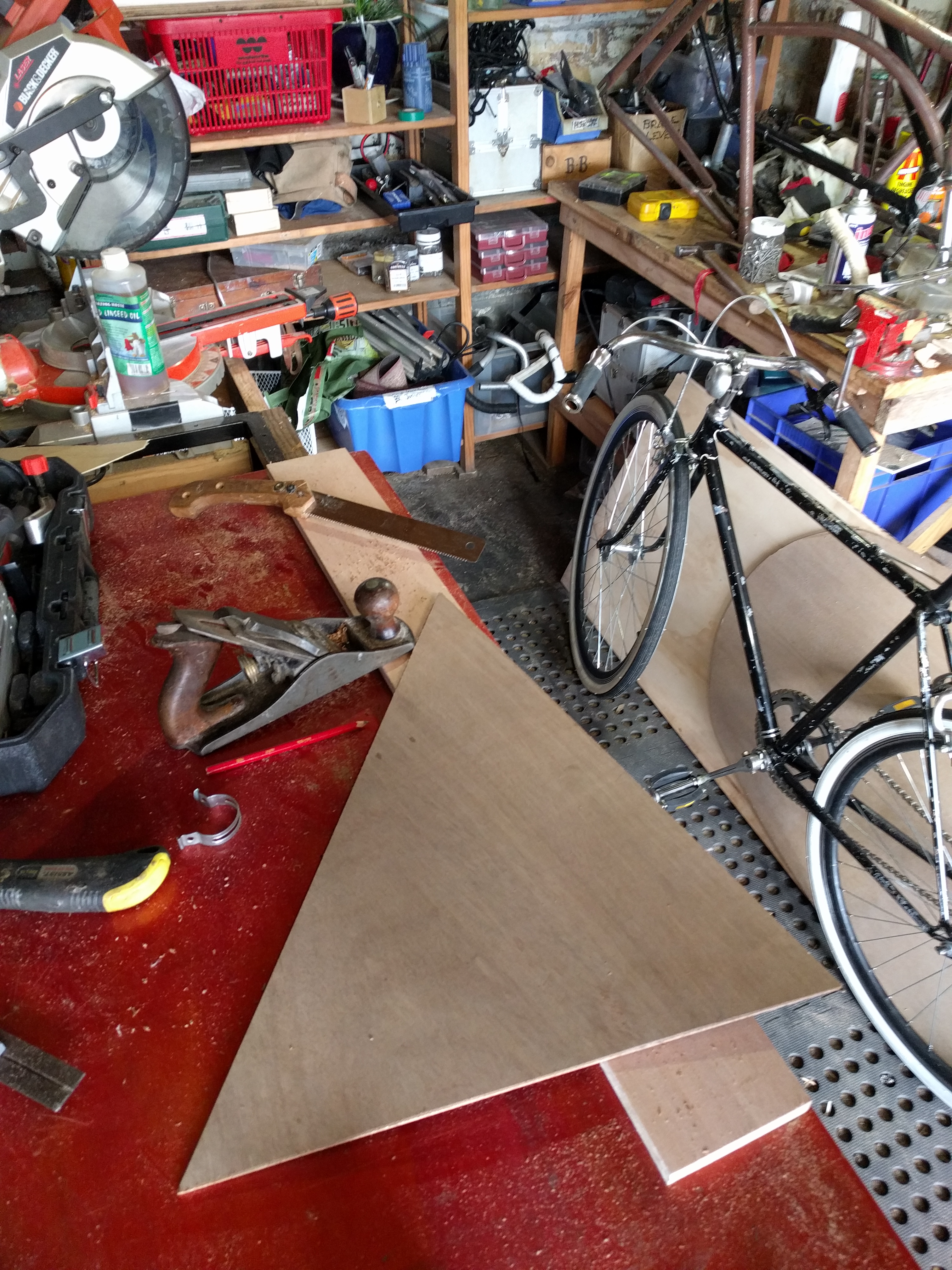 Raw plywood cut carefully to fit inside the bike's main triangle